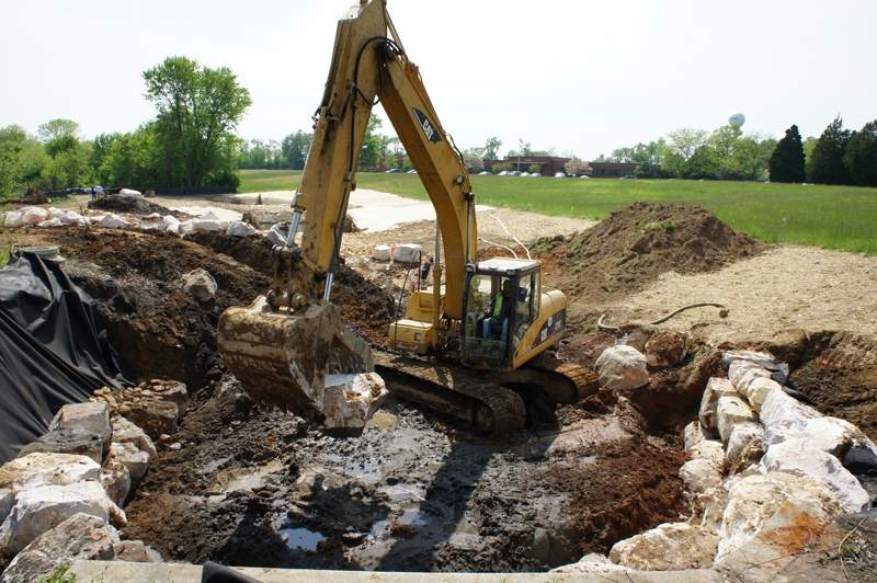 Some of the 16,000 cubic feet of sandstone boulders being placed  to bolster each conveyance pond.