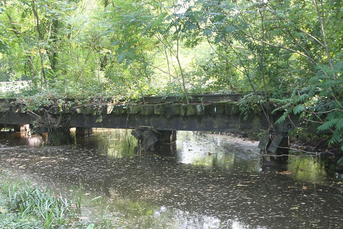 Radcliffe Creek flowing under the old railroad bridge behind Brooks Tavern (the old Mill), and across from the Rail Trail and the site for the Mabel Mumford Gateway Park. 