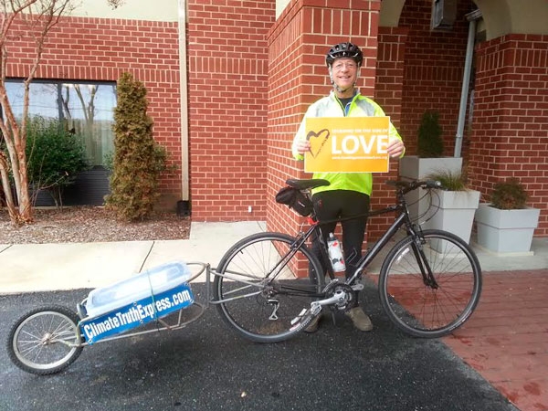     Sam Caldwell, visiting Washington College while on his way to Washington, DC. He is shown here showing the Unitarian Universalists' "Standing on the Side of Love" logo.