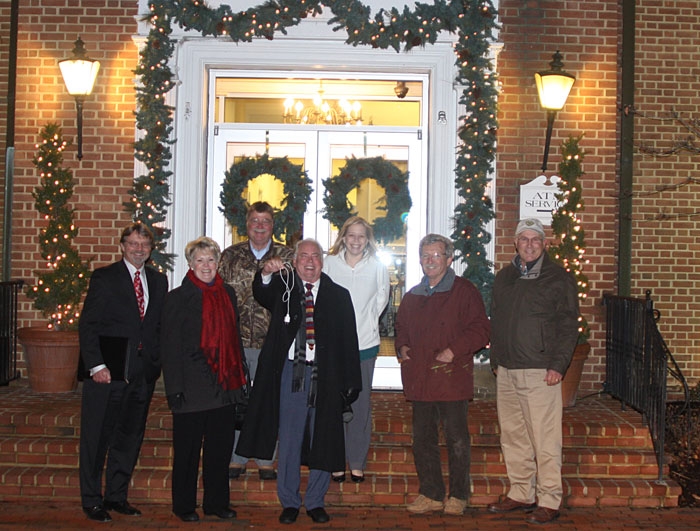 Ralph Dowling and Peoples Bank crew celebrating the bank's holiday illumination. (We think Mr Dowling is holding the ceremonial electrical cord, but are wondering how the lights stay on if he has it in his hand?)