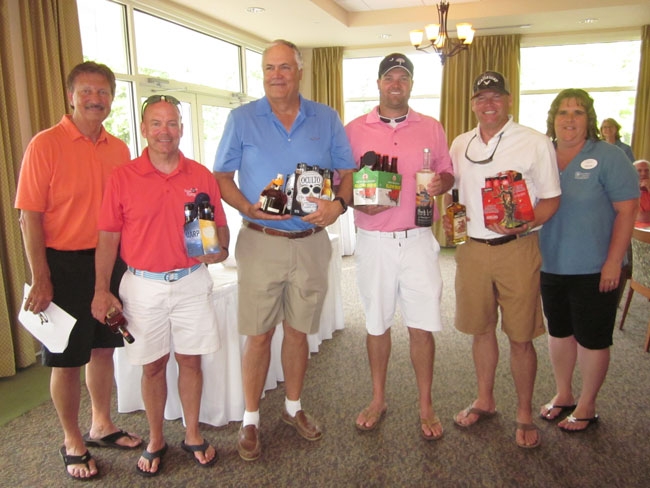Doug Pierson (left), a member of the Compass Regional Hospice board and Golf Tournament Committee, presented prizes to 1st place winners (left to right) Marty Mitchell, Larry Stone, Tim Clark and Matt Spedden. Also pictured is Compass Regional Hospice Development Officer Kenda Leager. 