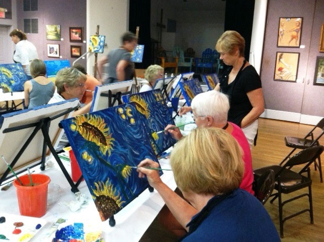 Paintbrush Partygoers work to complete artist instructor Sarah Lyle’s Starry Sunflowers