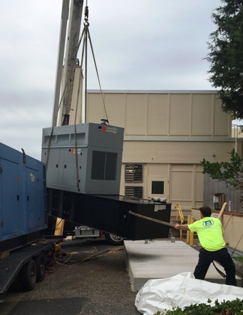The first of two new emergency generators installed at UM Shore Medical Center at Chestertown is shown being lowered by crane on to its reinforced concrete pad. The generators are a permanent replacement for older equipment used to ensure continuous electricity to the medical center during a power outage.  