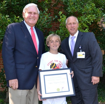 Dylan Conner of Chestertown (center) receives the first-ever Creating Healthier Communities Together Award from John Dillon, chairman, UM Shore Regional Health Board of Directors (left) and Kenneth Kozel, president and CEO, UM Shore Regional Health (right).