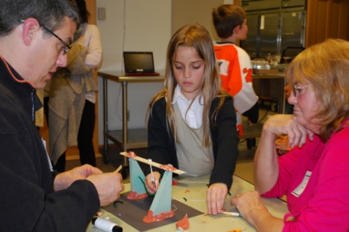 Edward and Anna Greene of Middletown worked with Anna’s grandmother, Joyce Francisco of Elkton, MD, to design their bridge at St. Anne’s Episcopal School’s Family STEM Night. 