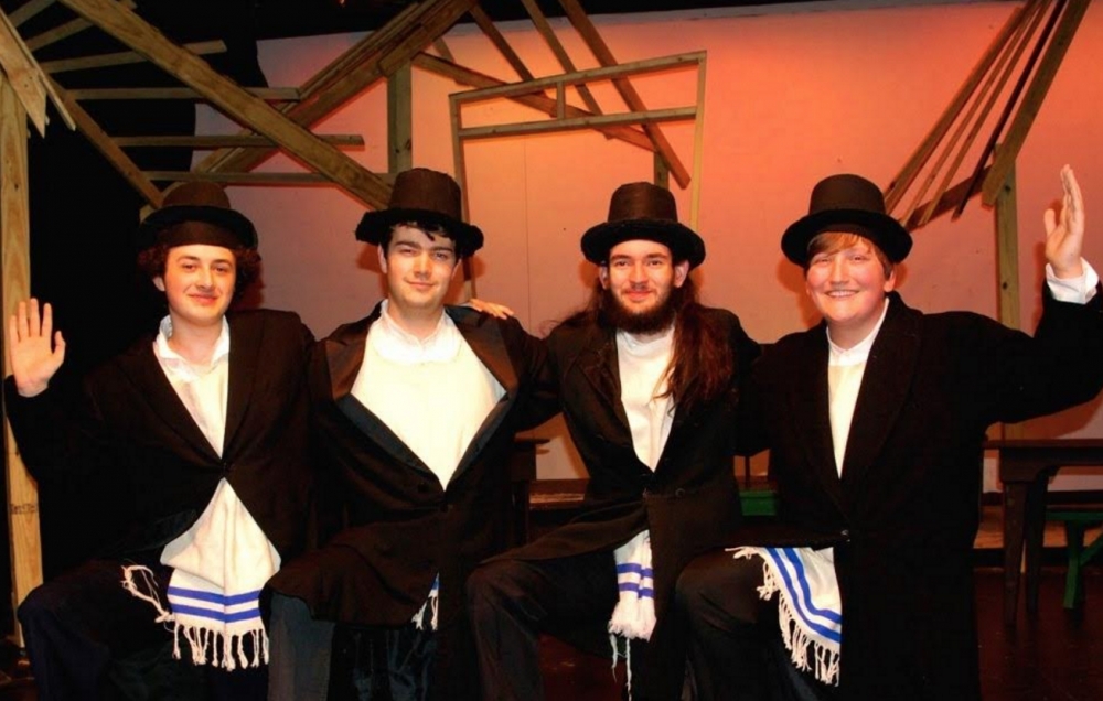 A wedding celebration commences with a traditional bottle dance by villagers (L to R: Bryce Sullivan, Robert Branning, Jusden Messick, and Elliott Morotti) in Church Hill Theatre’s production of Fiddler on the Roof.