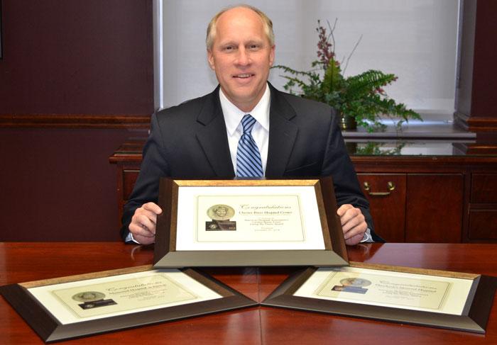 CUTLINE:  UM Shore Regional Health President and CEO Ken Kozel displays the Living the Vision award certificates presented to UM Shore Medical Centers at Chestertown, Dorchester and Easton by the American Hospital Association. 