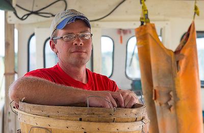 C.J. Canby takes a rest aboard his boat, Miss Paula, after a long morning of crabbing. (Dave Harp)